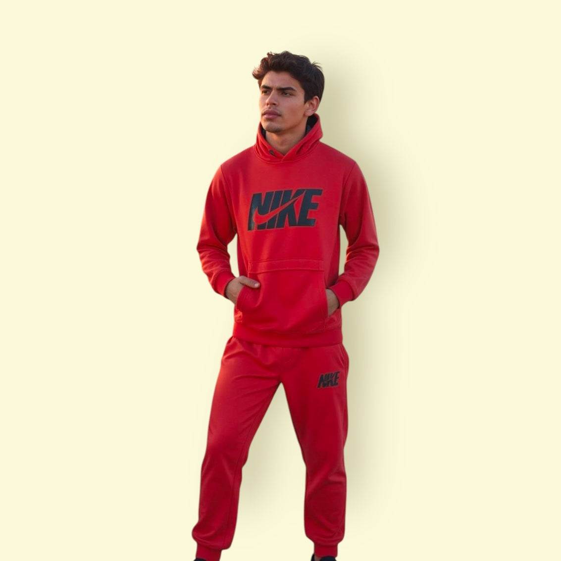 Man wearing red Nike tracksuit with hoodie and joggers, unisex athletic wear