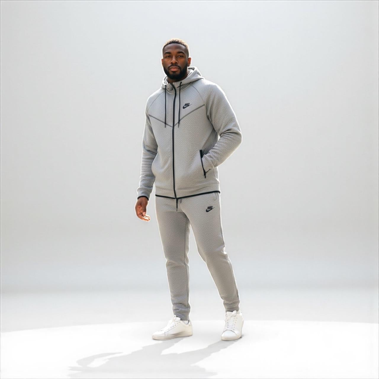 Man wearing gray Nike tech fleece tracksuit with hooded jacket and pants