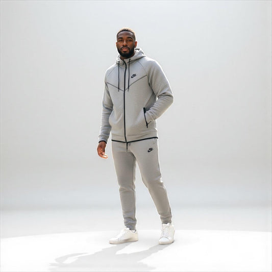 Man wearing gray Nike tech fleece tracksuit with hooded jacket and pants