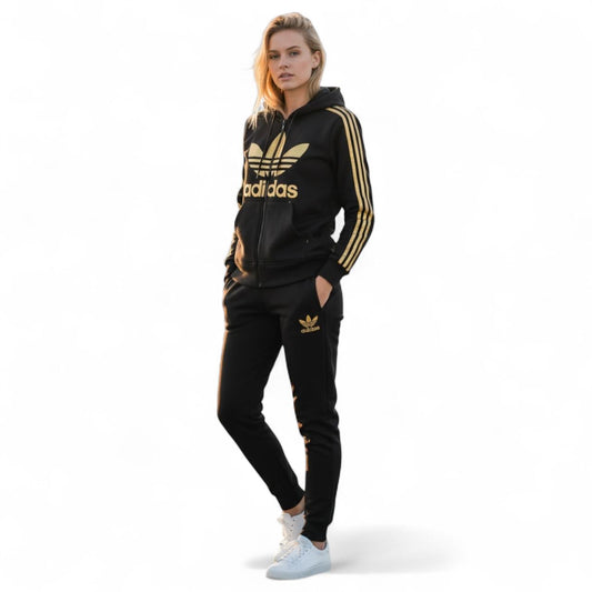 Women's Adidas tracksuit in black with yellow stripes and logo, featuring a hoodie and jogger pants.