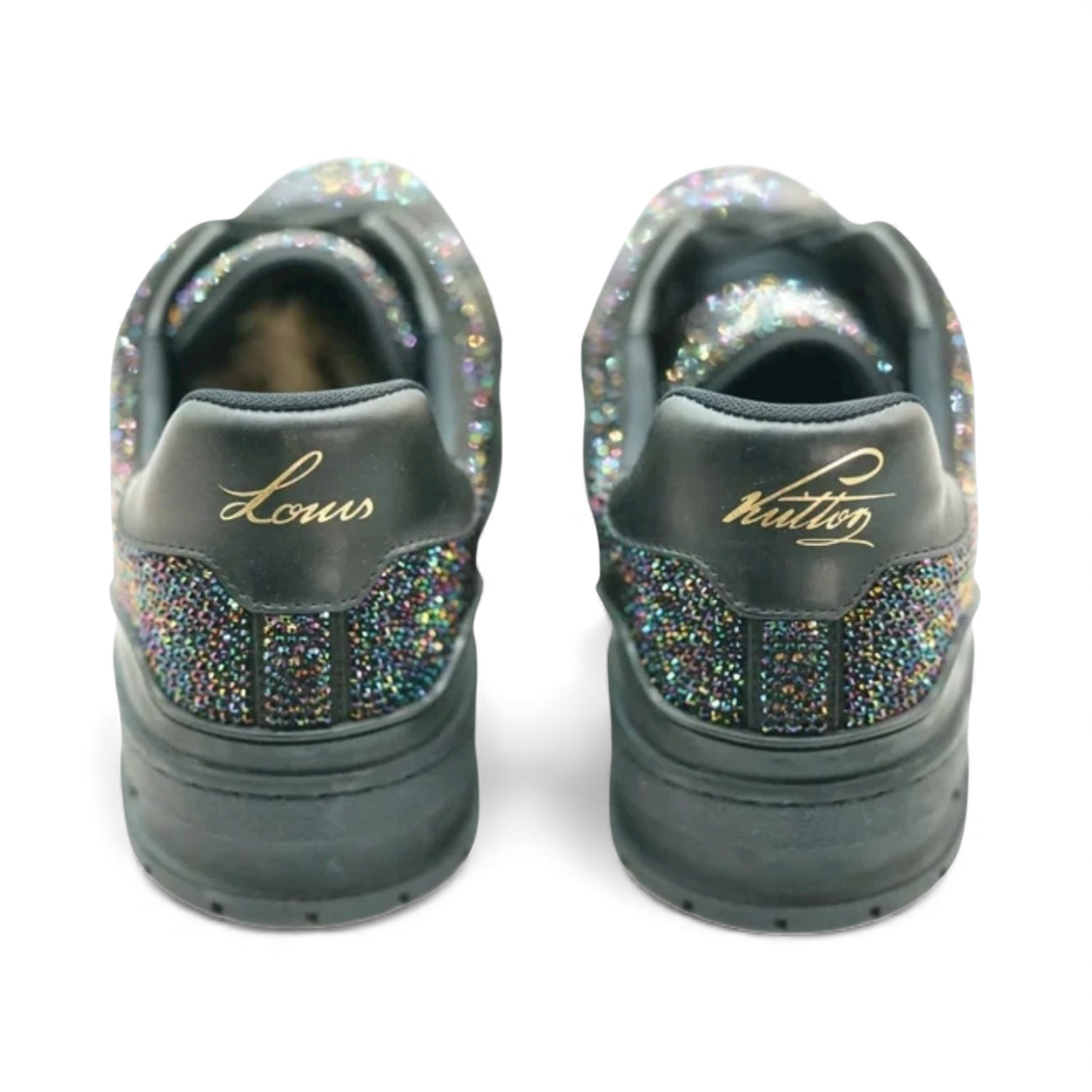 Black LV trainer sneakers adorned with sparkling Swarovski crystals and gold luxury branding on the heels