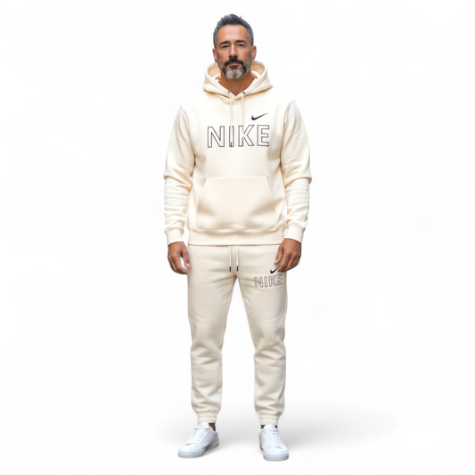 Man wearing beige Nike tech fleece tracksuit with hoodie and joggers on white background