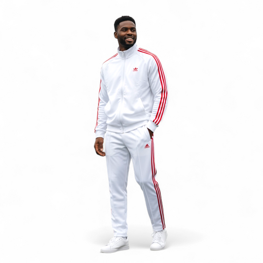Man wearing white adidas tech fleece tracksuit with red stripes and logo, standing and smiling